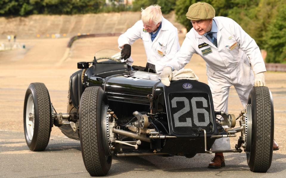 Volunteers Garry Matthews and Ralph Brough cleaning the winning car - Russell Sach