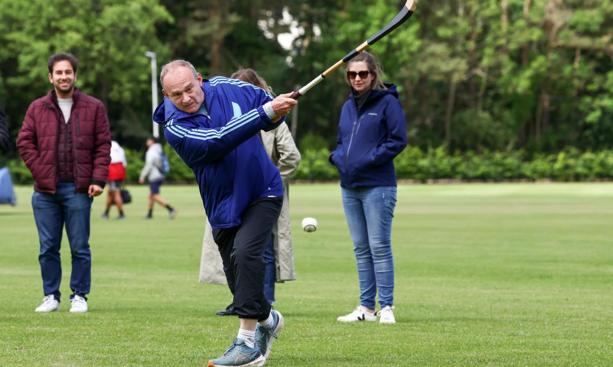 <span>Ed Davey joins the local candidate and Scottish Liberal Democrat deputy leader Wendy Chamberlain to play shinty in St Andrews, Scotland.</span><span>Photograph: Jeff J Mitchell/Getty Images</span>