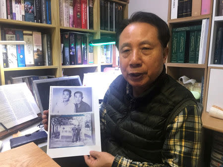 Ahn Yong-soo, whose brother was a South Korean prisoner of war captured by communist Vietnamese during the Vietnam War and sold to North Korean military officers, poses for photographs with a picture of his brother, at his home in Seoul, South Korea, February 12, 2019. Picture taken on February 12, 2019 REUTERS/Park Ju-min