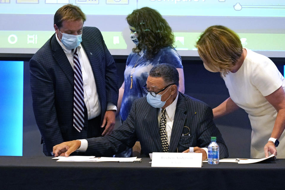 Mississippi State Flag Commission Chairman Rueben Anderson, seated, reviews the results of the commission vote on the flag to be placed on the November ballot during a meeting at the Two Mississippi Museums in Jackson, Miss., Wednesday, Sept. 2, 2020. The New Magnolia Flag, is now known as the "In God We Trust Flag" as per a vote by the commission and will be on the ballot in the fall.3(AP Photo/Rogelio V. Solis)