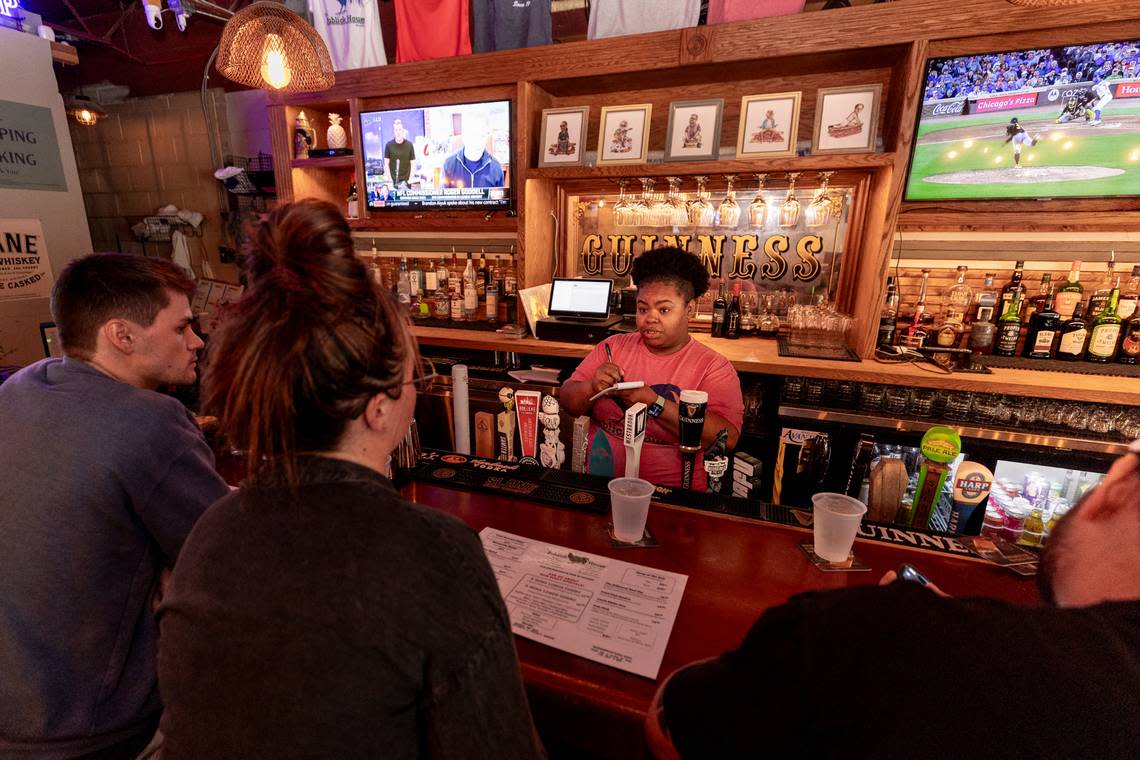 Asha Jamison takes lunch orders from Austin Shealy, left, Madison Burlett and Mario Villegas at Publick House.