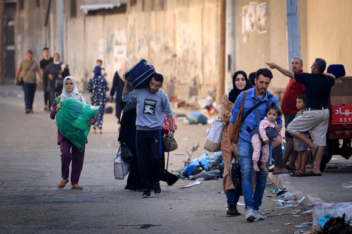 Palestinians with their belongings flee to safer areas in Gaza City after Israeli air strikes (AFP via Getty Images)