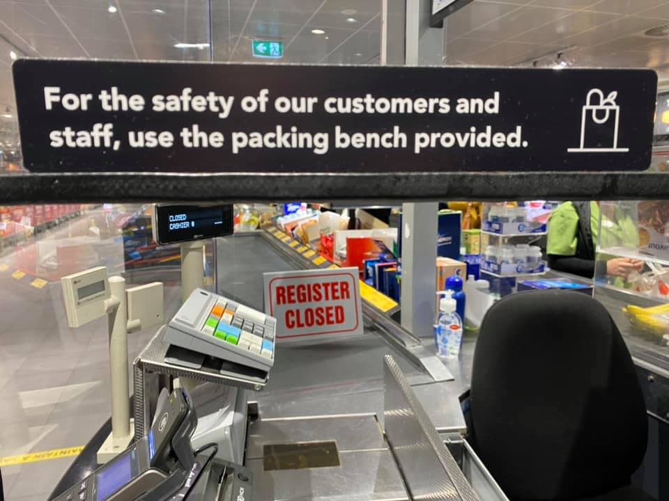 Image of Aldi sign reading: For the safety of our customers and staff, use the packing bench provided