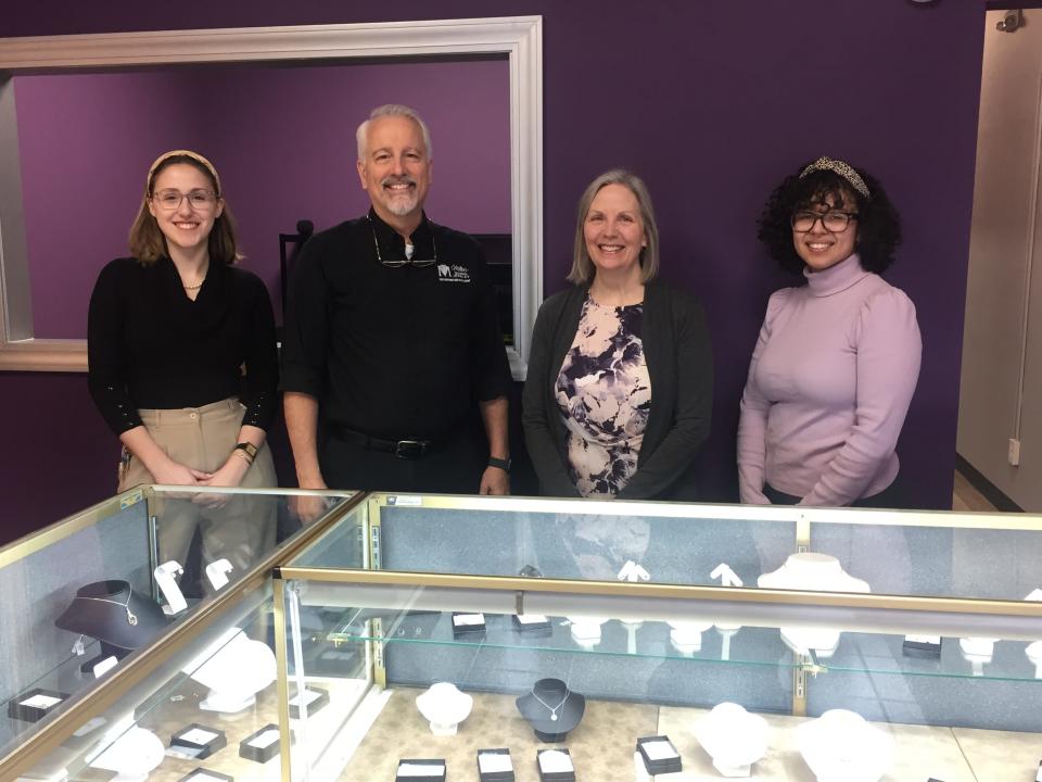 Andy Abrams, Mike Miller, Deb Miller and Savannah Gould pose in front of a display case at Miller's Diamond Jewelry, which has moved to the Ace Hardware Plaza at 1523A Lexington Ave.