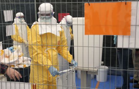 A volunteer for Medecins Sans Frontieres (MSF), or Doctors Without Borders, receives training on how to handle personal protective equipment during courses in Brussels October 15, 2014, which is aimed to help deal with the Ebola disease in West Africa. REUTERS/Francois Lenoir