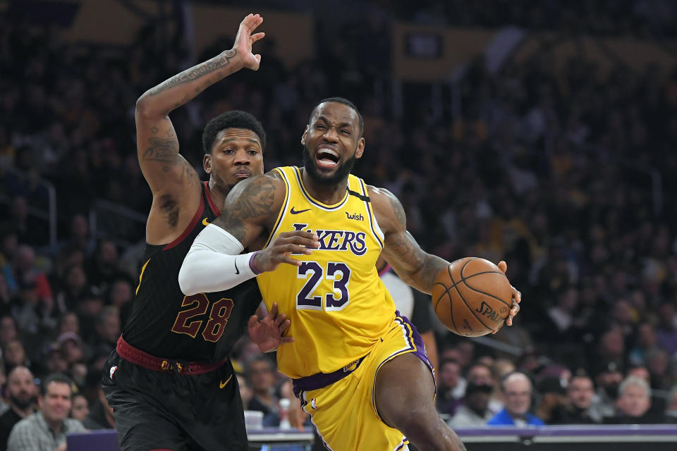 Los Angeles Lakers forward LeBron James, right, drives toward the basket as Cleveland Cavaliers forward Alfonzo McKinnie defends during the second half of an NBA basketball game, Monday, Jan. 13, 2020, in Los Angeles. The Lakers won 128-99. (AP Photo/Mark J. Terrill)