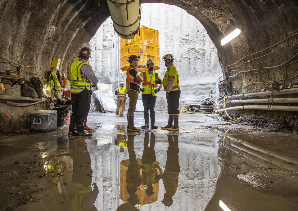 U.S. Secretary of Transportation Pete Buttigieg, center, receives a tour of an underground tunnel for the expansion of the Hartsfield–Jackson Atlanta International Airport plane train tunnel at the Hartsfield–Jackson Atlanta International Airport, Friday, May 21, 2021, in Atlanta. (Alyssa Pointer/Atlanta Journal-Constitution via AP)