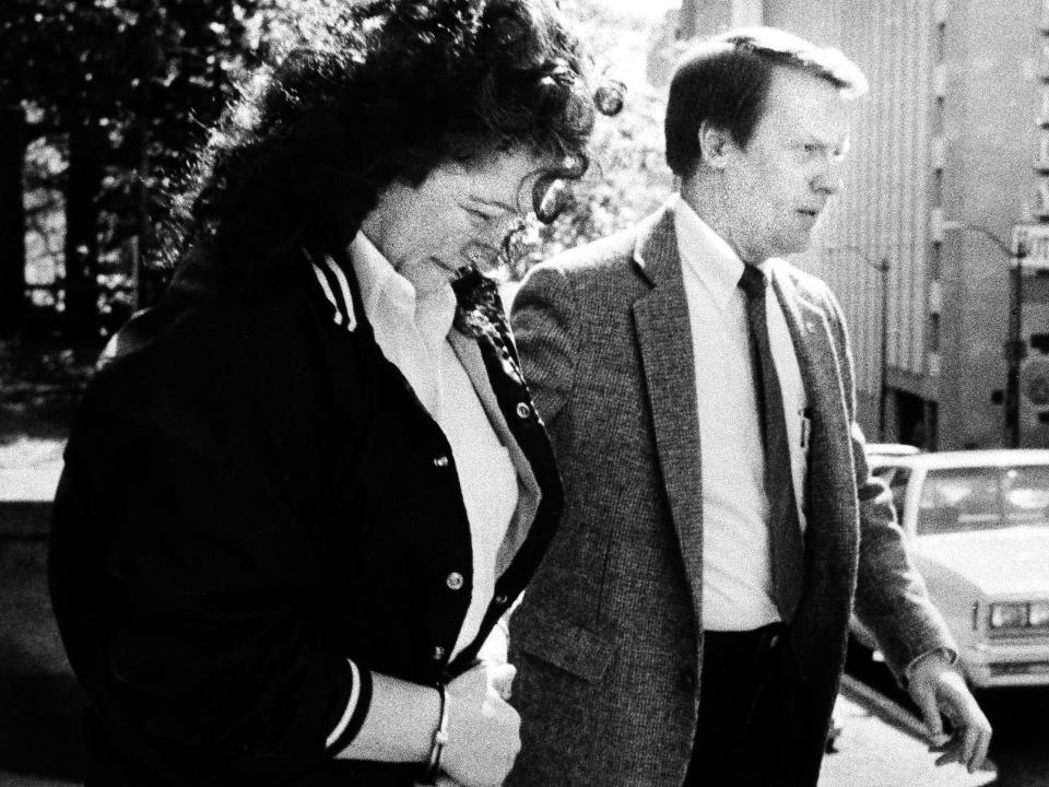 Stella Nickell, who lethally poisoned two people, is led away in handcuffs from court in 1988.