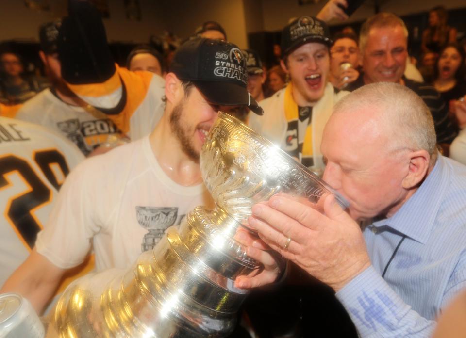 <p><span>Pittsburgh Penguins </span>general manager Jim Rutherford drinks from the Stanley Cup with an assist from center Sidney Crosby after defeating the Nashville Predators in Game 6 of the 2017 Stanley Cup Final at Bridgestone Arena. Credit: Dave Sandford/NHLI/Pool Photo via USA TODAY Sports </p>