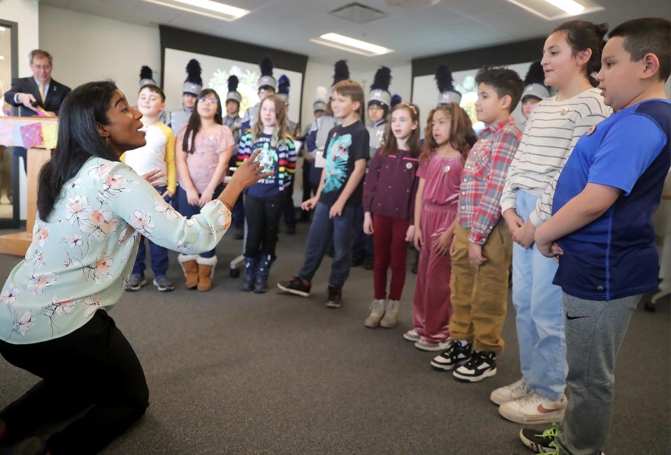 Ariana Douglas, a music teacher with the Banta Bilingual Elementary School in Menasha, leads students in song during the city's sesquicentennial celebration in March at the Menasha City Center.