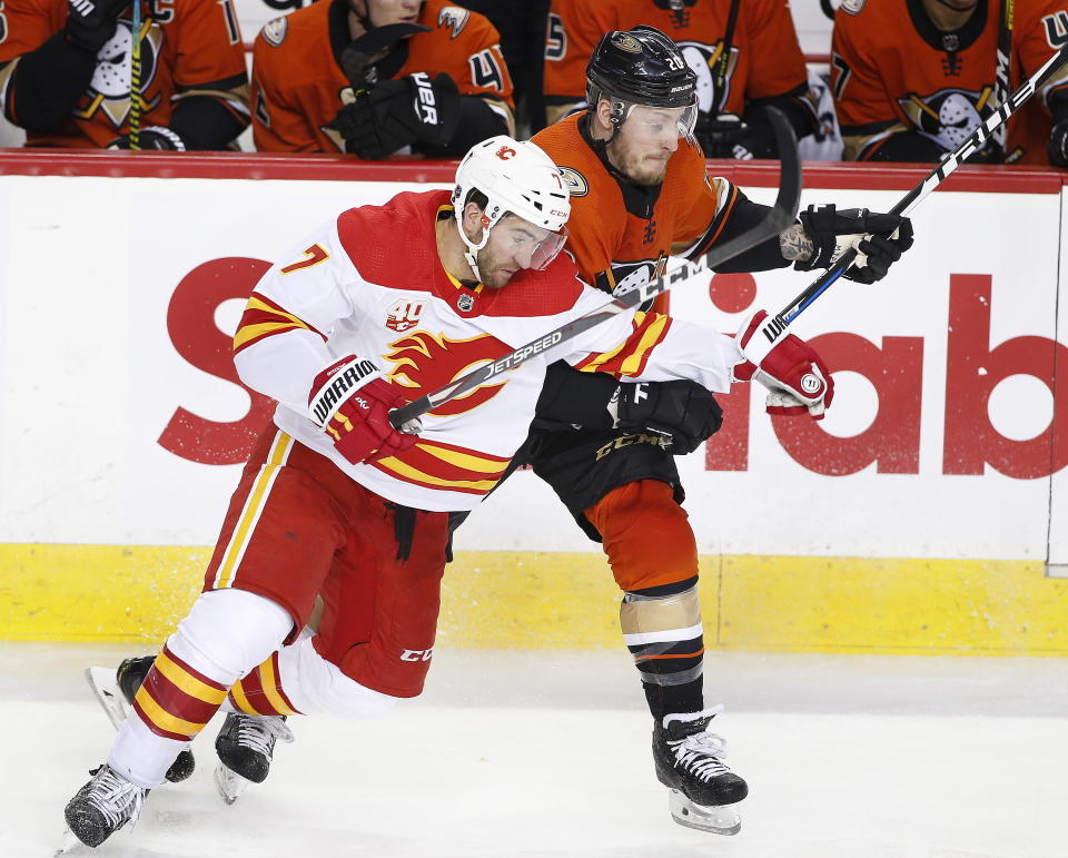 Anaheim Ducks' Nicolas Deslauriers, right, battles with Calgary Flames' TJ Brodie during second period NHL hockey action in Calgary, Alberta, Monday, Feb. 17, 2020. (Larry MacDougal/The Canadian Press via AP)