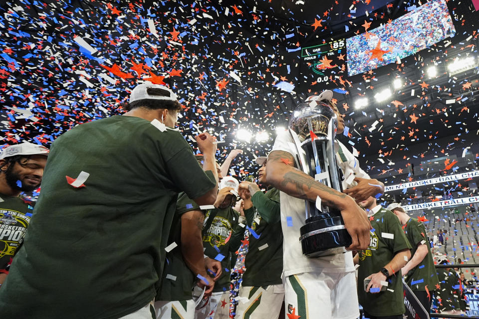 UAB's Christian Coleman holds the trophy after his team defeated Temple in an NCAA college basketball game in the championship of the American Athletic Conference tournament, Sunday, March 17, 2024, in Fort Worth, Texas. UAB won 85-69. (AP Photo/Julio Cortez)