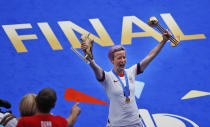 United States' Megan Rapinoe lifts the trophies after her team won the Women's World Cup final soccer match between US and The Netherlands at the Stade de Lyon in Decines, outside Lyon, France, Sunday, July 7, 2019. (AP Photo/Francois Mori)