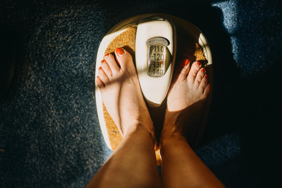 Close-up of a person's feet on a mechanical bathroom scale