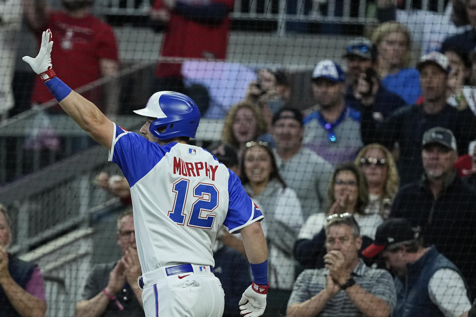 Atlanta Braves' Sean Murphy (12) waves after scoring a home run in the fourth inning of a baseball game against the Houston Astros, Saturday, April 22, 2023, in Atlanta. (AP Photo/Brynn Anderson)