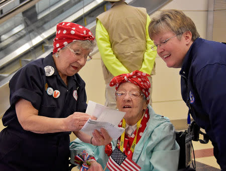 The Army Engineer Spouses Club welcome a group of more than 30 Michigan-based "Rosie the Riveters" at Ronald Reagan International Airport in Arlington, Virginia, U.S., March 22, 2016. Now in their 80s and 90s, these women entered the American workforce in the early 1940's during World War II as male enlistment in the war left gaping holes in the industrial labor force. Cynthia Mitchell/U.S. Army Corps of Engineers, Baltimore District/Handout via REUTERS