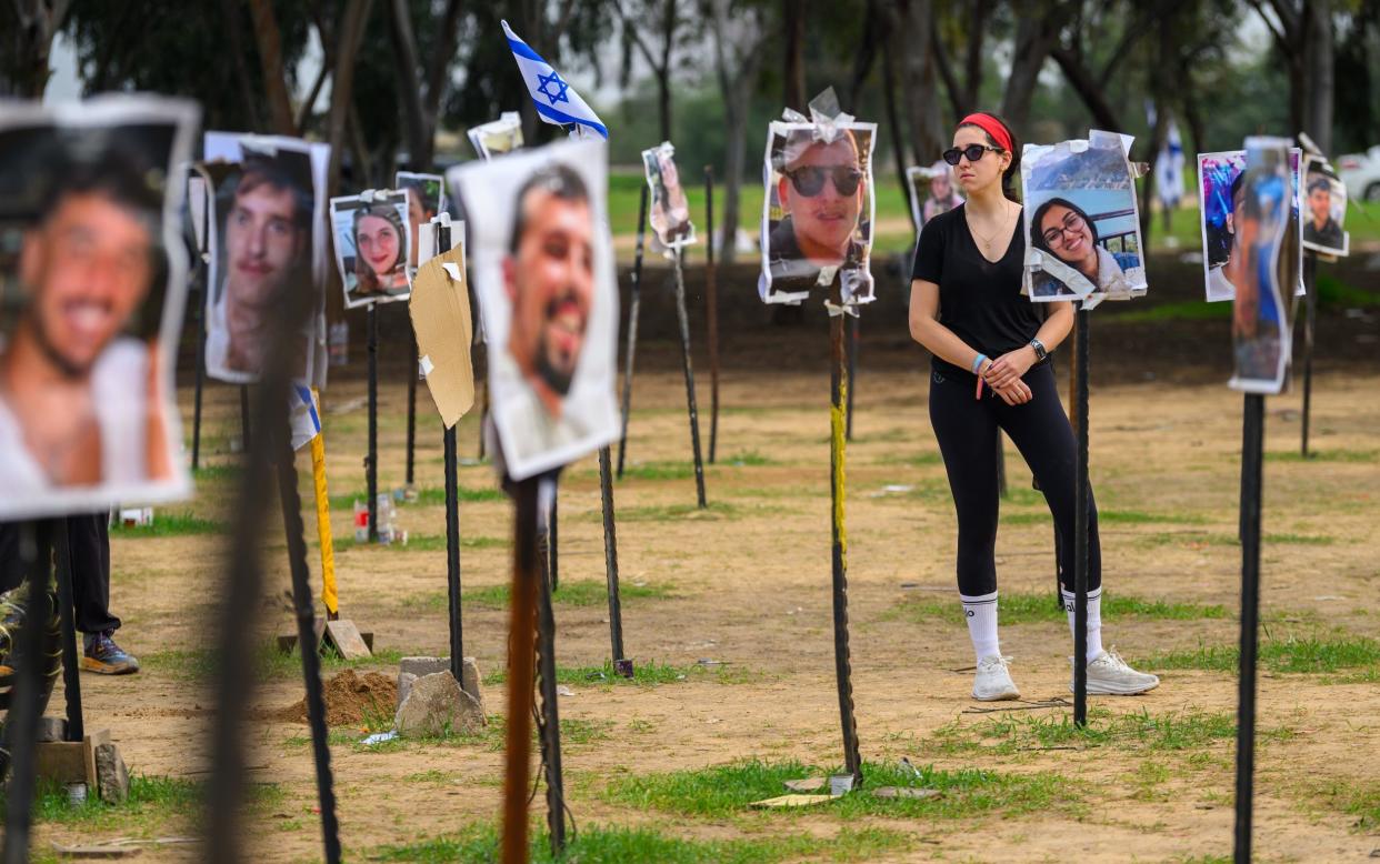 Atara, from London, visits a memorial for the first time since the Oct 7th attack on December 17, 2023 in Re'im, Israel