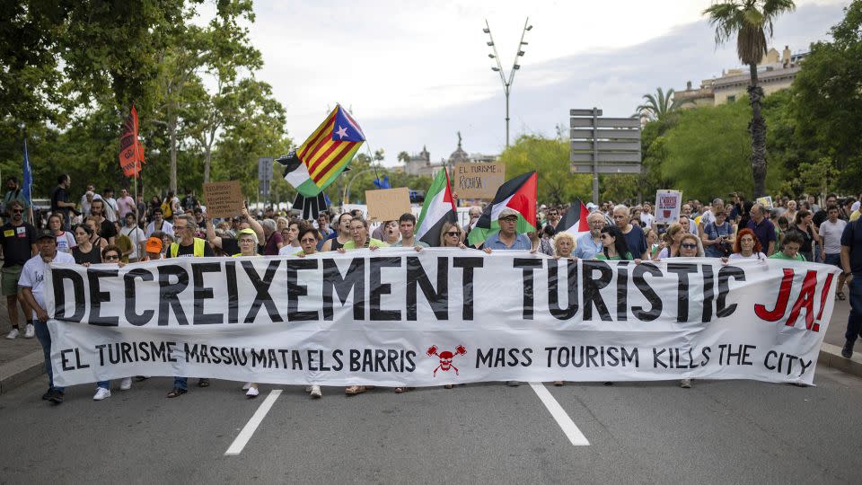 Barcelona residents held an anti-tourism march with signs in Catalan and English. - Lorena Sopêna/Europa Press/AP