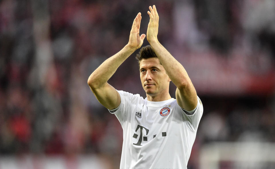 FILE - In this Sunday, Feb. 16, 2020 file photo, Bayern's Robert Lewandowski celebrates with supporters after winning their German Bundesliga soccer match against 1. FC Cologne in Cologne, Germany. The coronavirus pandemic has changed almost everything about soccer in Germany, except Bayern Munich's chances of winning. When the Bundesliga resumes on Saturday, May 16 after a two-month suspension caused by the pandemic, Borussia Dortmund and Leipzig will be Bayern's main challengers. Bayern’s Robert Lewandowski, Borussia Dortmund’s Erling Haaland and Leipzig’s Timo Werner have all been crucial to their team's challenges with explosive scoring form. (AP Photo/Martin Meissner, file)