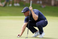 Bryson DeChambeau places his ball before putting on the second hole during second round play in the Tour Championship golf tournament at East Lake Golf Club, Friday, Sept. 3, 2021, in Atlanta. (AP Photo/Brynn Anderson)