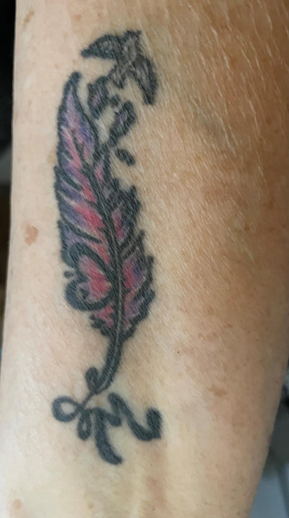 Cheryl Cook's tattoo represents her late husband Mick using a feather, heart, bird and his initial.