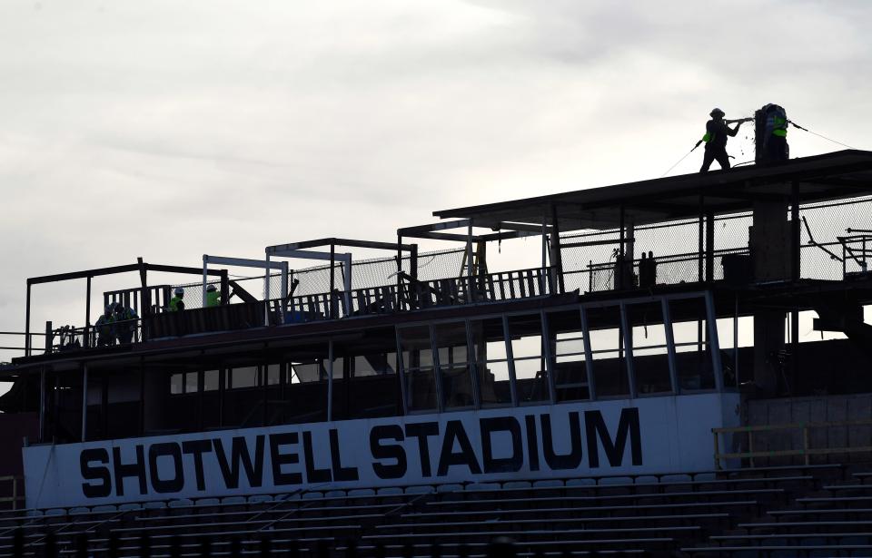 Workers chip away at concrete columns as renovations at the Shotwell Stadium press box continue Wednesday.