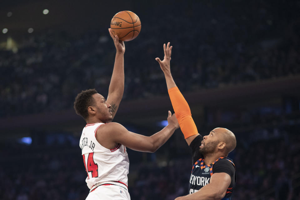 Chicago Bulls center Wendell Carter Jr. (34) shoots over New York Knicks center Taj Gibson (67) during the first half of an NBA basketball game, Saturday, Feb. 29, 2020 in New York. (AP Photo/Mark Lennihan)