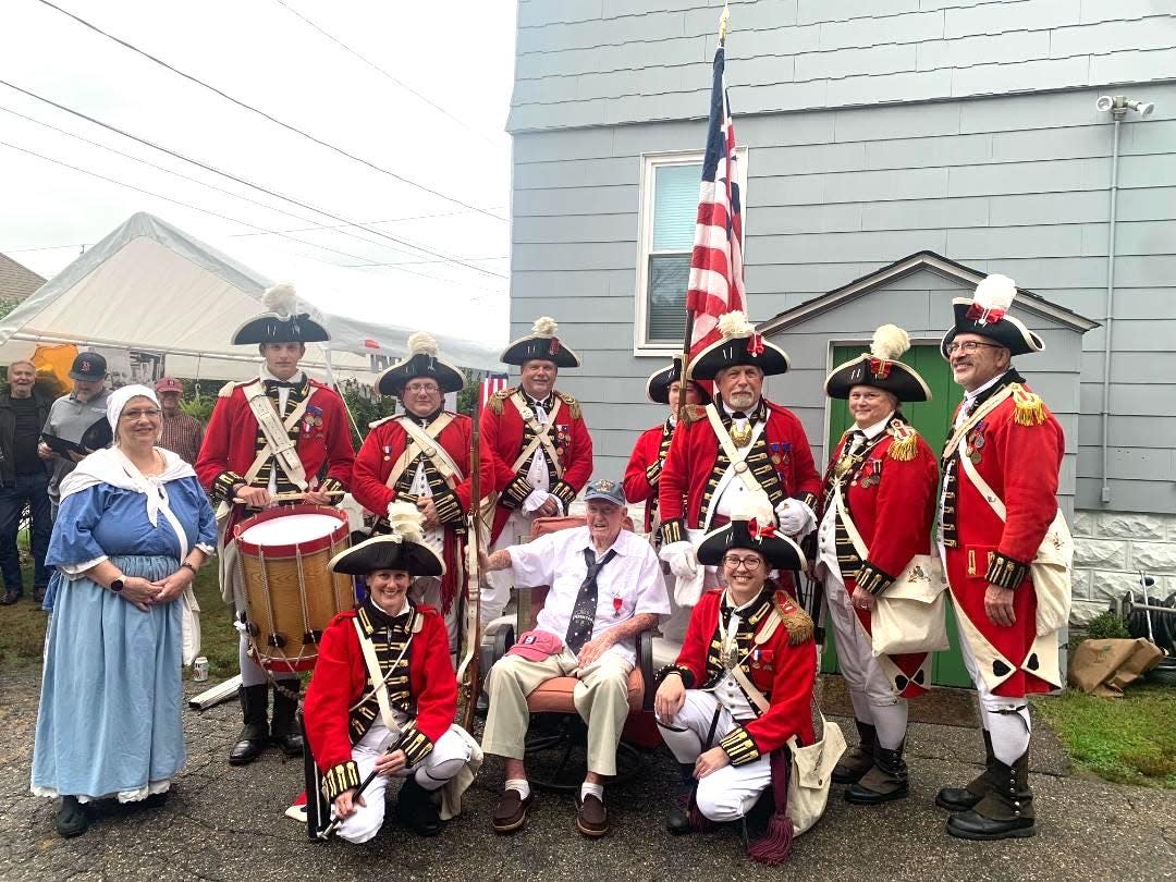 Celebrating his 100th birthday on Oct. 7, retired naval aviator and World War II veteran John Bradley sits amidst a contingent of Pawtuxet Rangers.