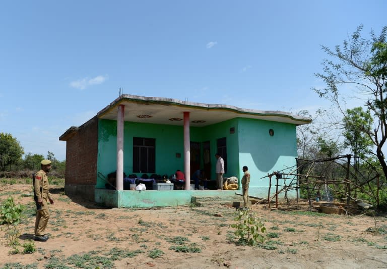 Indian policemen guard the house of the eight-year-old girl, who was raped and murdered, at Rasana village in Kathua district of Jammu