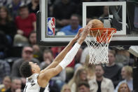 San Antonio Spurs center Victor Wembanyama (1) dunks against the Utah Jazz during the first half of an NBA basketball game Wednesday, March 27, 2024, in Salt Lake City. (AP Photo/Rick Bowmer)