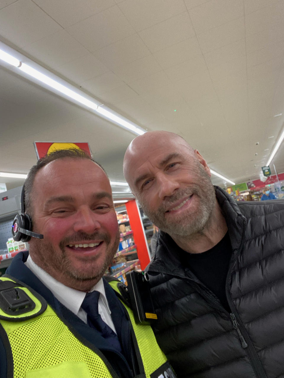 John Travolta posed with a Morrisons security guard during his visit to Norfolk. (SWNS)