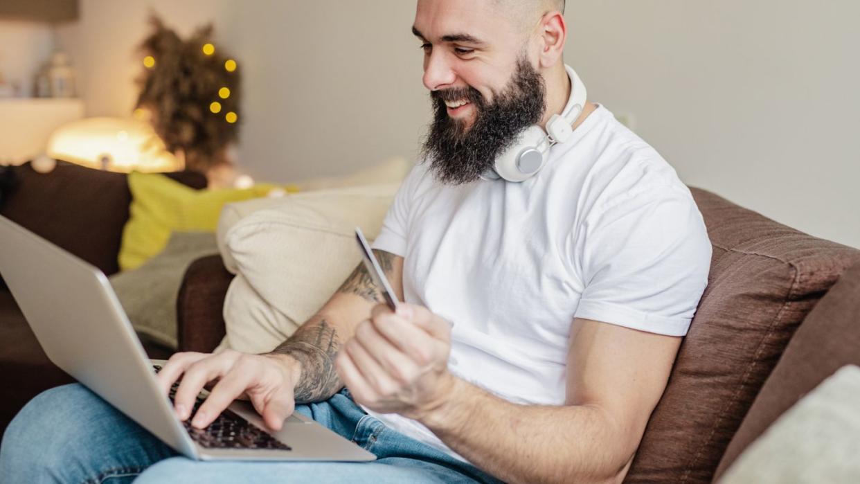 man using card for online shopping at home