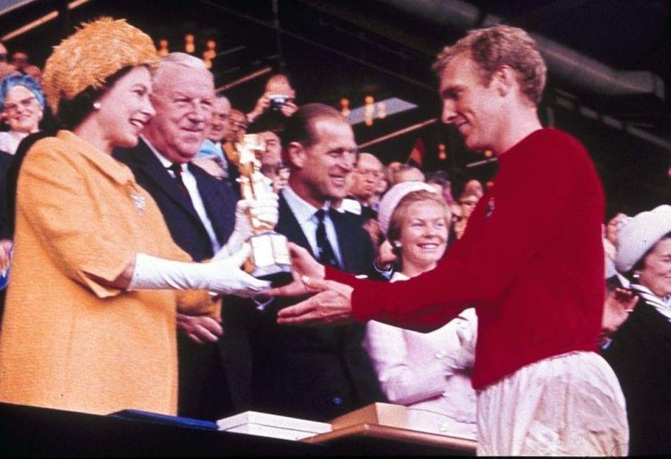 England captain Bobby Moore receives the Jules Rimet Trophy from The Queen after England defeated West Germany in 1966 (AP)