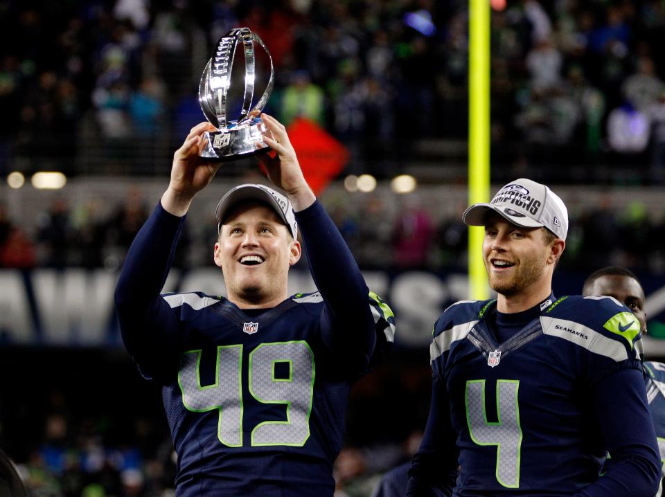 Clint Gresham and kicker Steven Hauschka, No. 49 and No. 4 of the Seattle Seahawks, respectively, celebrate with the George Halas Trophy after the Seahawks' 23-17 victory against the San Francisco 49ers during the 2014 NFC Championship at CenturyLink Field on Jan. 19, 2014, in Seattle, Wash.