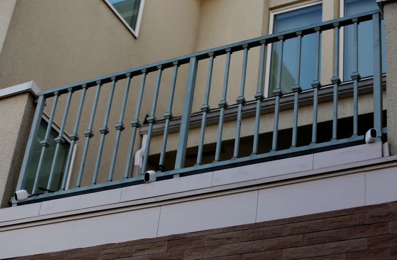 Three wireless security cameras installed above the entrance of the Tokyo residence of former Nissan chairman Carlos Ghosn are pictured, while prosecutors raid the house, in Tokyo