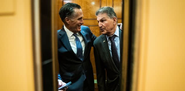 Sen. Joe Manchin (D-W.Va.) and Sen. Mitt Romney (R-Utah), head to a vote as senators make their way to a briefing on the war in Ukraine on Capitol Hill on Wednesday, March 30 in Washington, D.C. (Photo: The Washington Post via Getty Images)