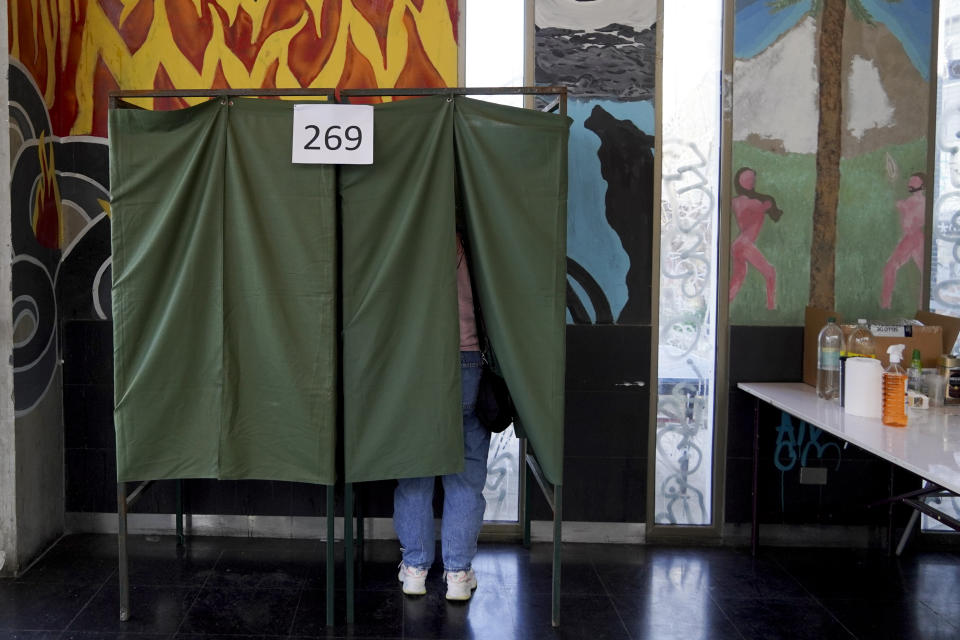 A man votes in a plebiscite on a new draft of the Constitution in Santiago, Chile, Sunday, Sept. 4, 2022. Chileans are deciding if they will replace the current Magna Carta imposed by a military dictatorship 41 years ago. (AP Photo/Matias Basualdo)