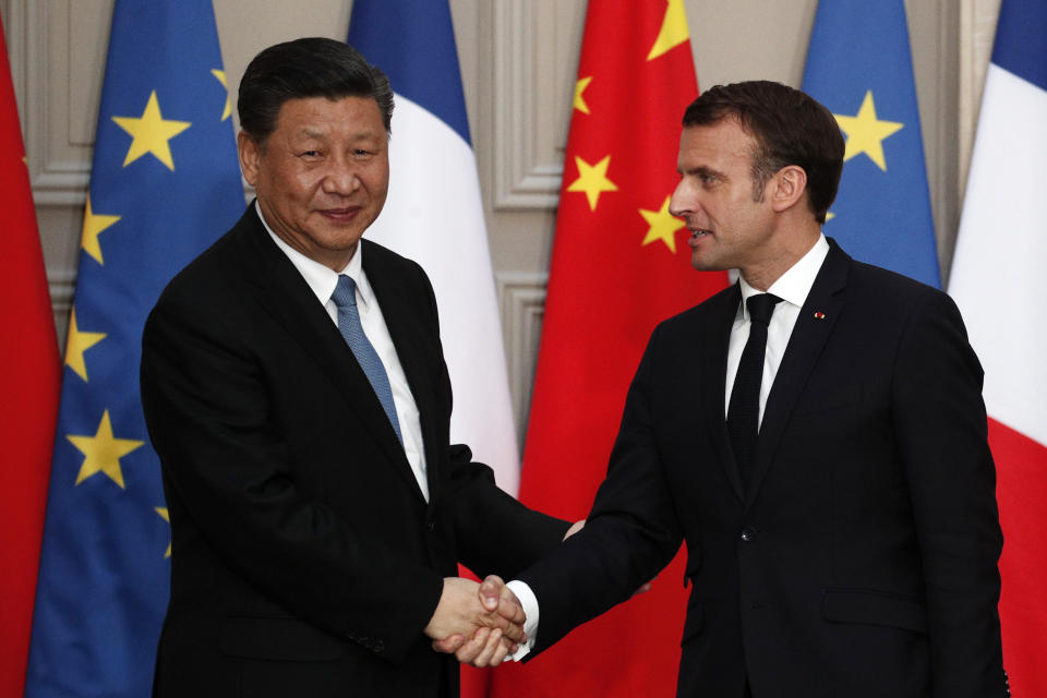 French President Emmanuel Macron, right, shakes hand with his Chinese counterpart Xi Jinping after a meeting at the Elysee Palace in Paris, France, Monday, March 25, 2019. Chinese President Xi Jinping was greeted with full honors Monday during a state visit to France in which he is expected to sign multibillion-dollar deals on energy, the food industry, transport and other sectors as well as a bilateral statement on climate change. (Yoan Valat/Pool Photo via AP)