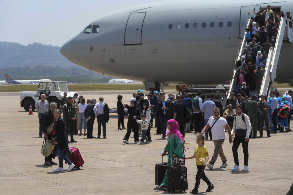 Brazilians deplane after the Brazilian Air Force evacuated them from Lebanon amid Israeli airstrikes, at the Air Force base in Guarulhos, greater Sao Paulo area, Brazil, Sunday, Oct. 6, 2024. (AP Photo/Andre Penner)