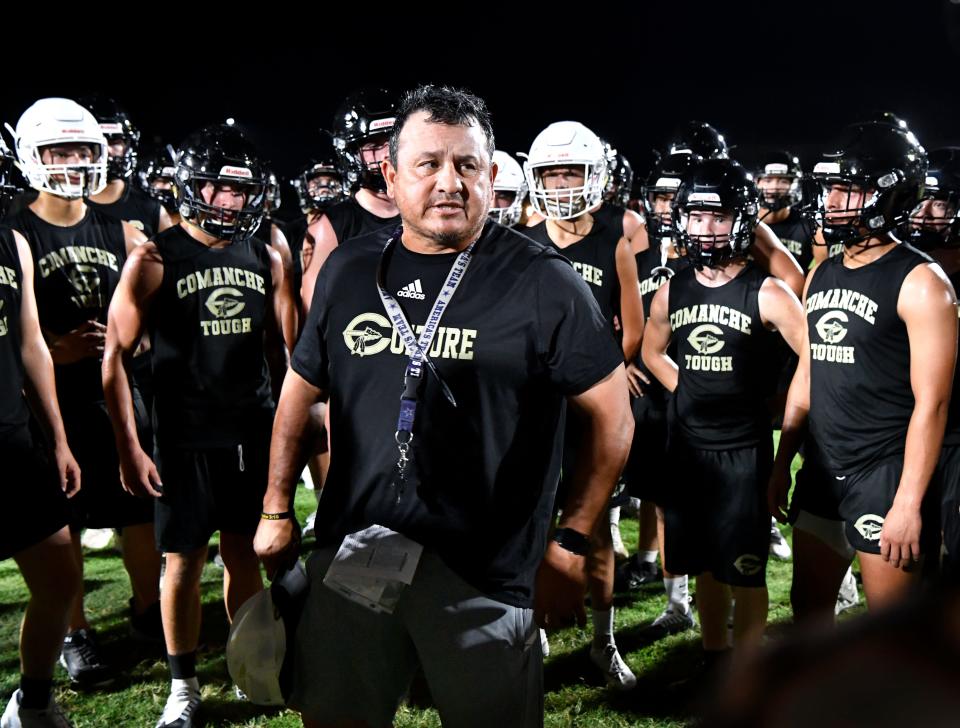 Comanche High School head football coach Jake Escobar encourages his players during a pause in their early-morning practice.