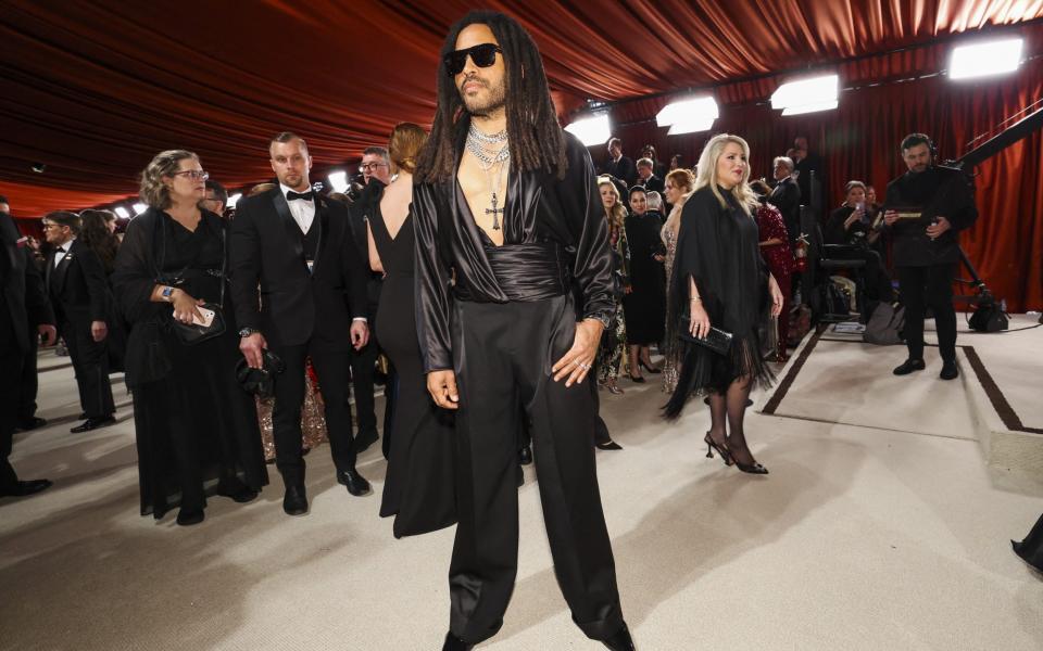 Lenny Kravitz poses on the champagne-colored red carpet during the Oscars arrivals at the 95th Academy Awards in Hollywood - Getty