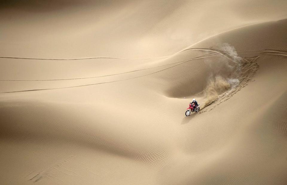 Wang Yirong of Hebei province rides his motorcycle in a desert during the China Taklimakan Rally and CCR Xinjiang Station, in Shanshan, Xinjiang Uighur Autonomous Region in this May 31, 2014 file photo. REUTERS/China Daily/Files (CHINA - Tags: SPORT MOTORSPORT TPX IMAGES OF THE DAY) CHINA OUT. NO COMMERCIAL OR EDITORIAL SALES IN CHINA