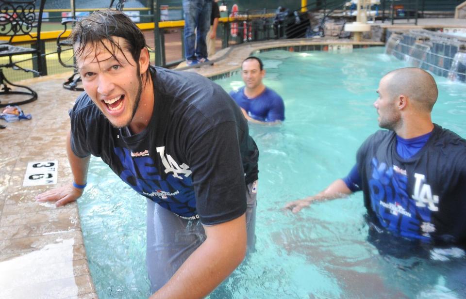 Dodgers' Clayton Kershaw celebrates in the pool with teammates after winning the division in Arizona on Sept. 19, 2013.