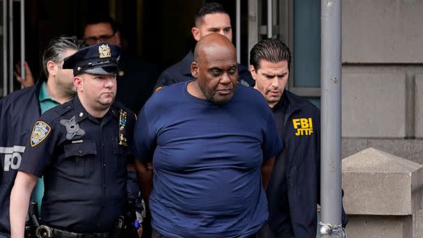 PHOTO: New York City Police and law enforcement officials lead subway shooting suspect Frank James, center, away from a police station, in New York, April 13, 2022. (Seth Wenig/AP, FILE)