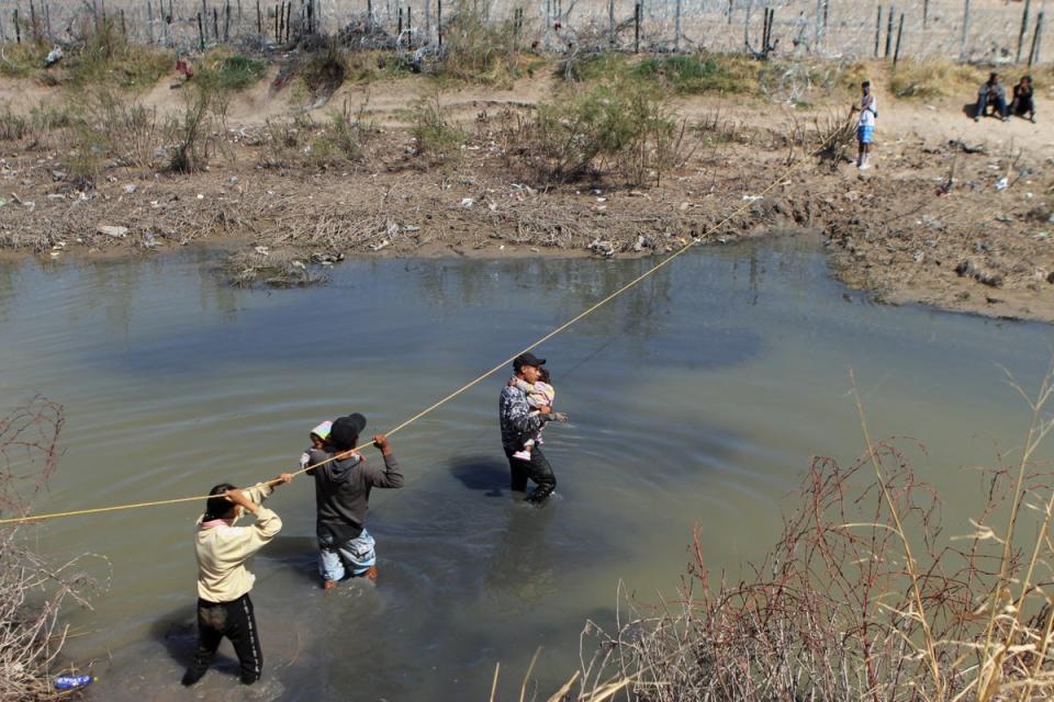 Migrants seeking asylum in the United States cross the Rio Bravo on the border of Ciudad Juarez, Chihuahua state, Mexico on 19 March 2024 (AFP via Getty Images)