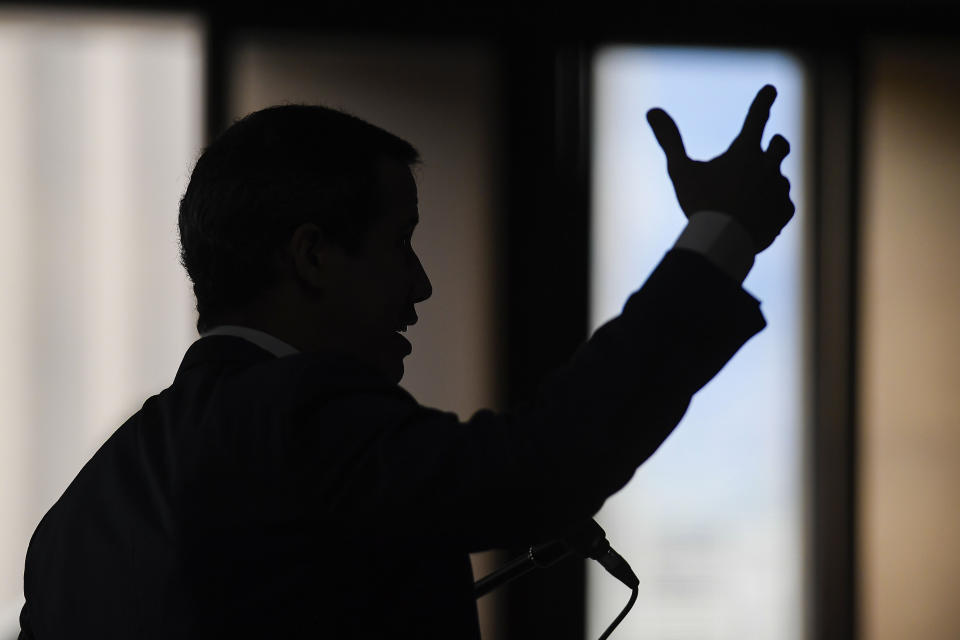 FILE - Venezuelan opposition leader Juan Guaido speaks to the press at the headquarters of Voluntad Popular political party in Caracas, Venezuela, Friday, Aug. 12, 2022. A few days into their long break, teachers have been marching by the thousands around the country, threatening to strike when school resumes or possibly even to abandon their profession after the government paid them only a tiny fraction of their annual vacation bonus. (AP Photo/Matias Delacroix, File)