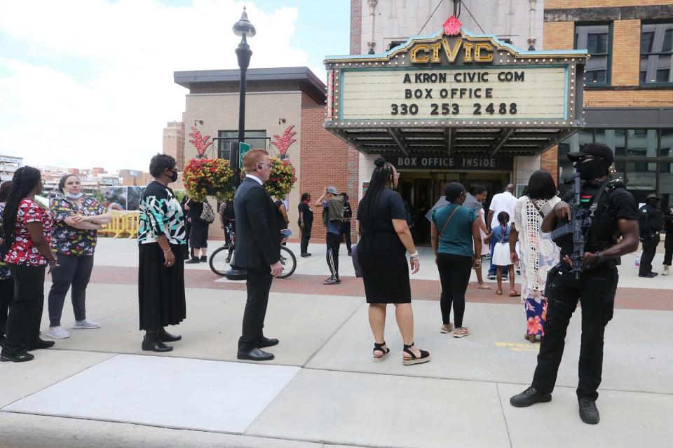Armed security guards stand outside the funeral for Jayland Walker as mourners arrive at the Akron Civic Theatre on July 13 in Ohio. Several protests followed Walker's death June 27, when he was shot by police dozens of times.