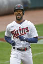 Minnesota Twins' Byron Buxton smiles while nearing home on his solo home run against the Seattle Mariners during the fifth inning of a baseball game Thursday, April 8, 2021, in Minneapolis. The Twins won 10-2. (AP Photo/Bruce Kluckhohn)