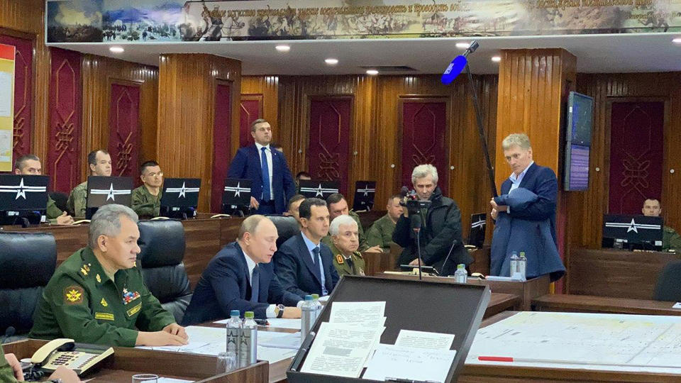 This image released by the Syrian Presidency shows Russian President Vladimir Putin, second left, in a meeting with Syrian President Bashar Assad and others, in Damascus, Syria on Tuesday, Jan. 7, 2020. Putin's visit is the second to the war-torn country where his troops have been fighting alongside Syrian government forces since 2015. (Syrian Presidency via AP)