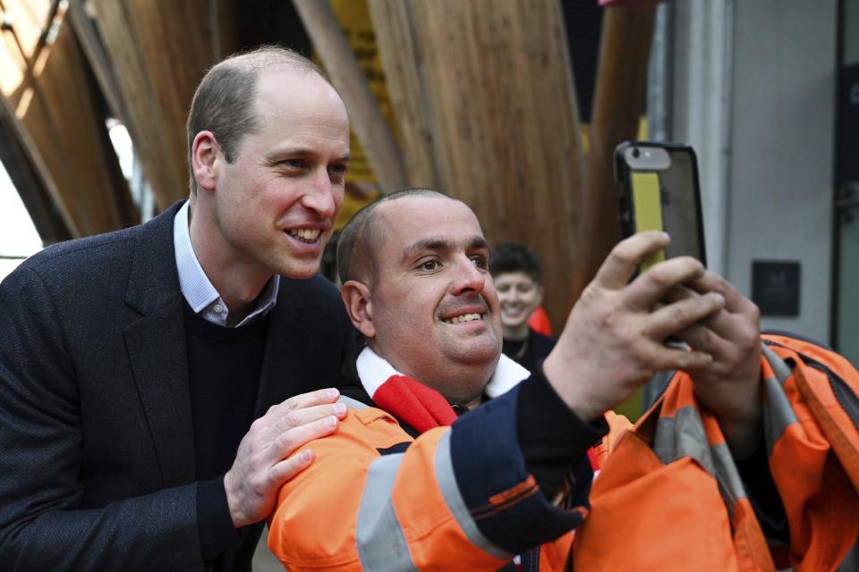 Britain's Prince William, left, poses for a selfie during his visit at Homewards Sheffield Local Coalition meeting, at the Millennium Gallery, in Sheffield, England, Tuesday, March 19, 2024. (Temilade Adelaja/PA via AP)